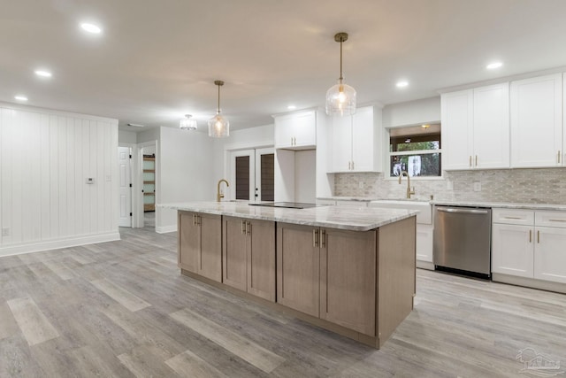 kitchen with dishwasher, a center island, decorative light fixtures, white cabinetry, and sink