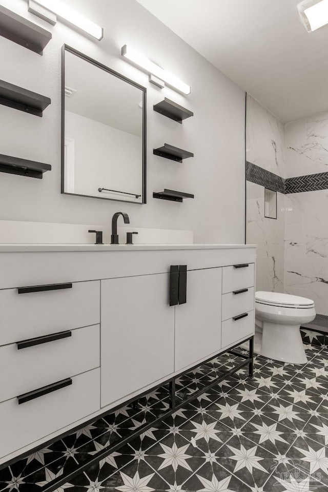 bathroom with vanity, walk in shower, and toilet