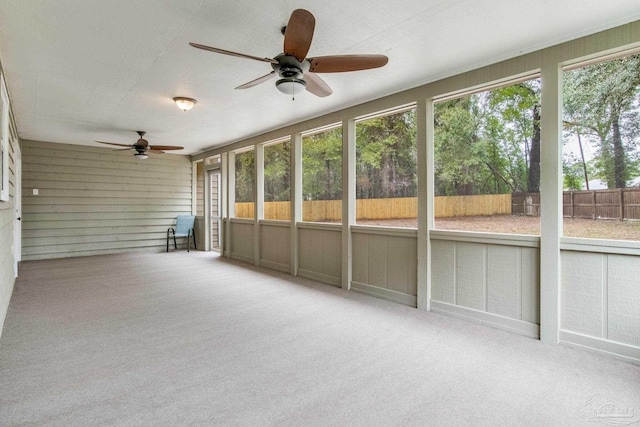 unfurnished sunroom with ceiling fan and a wealth of natural light