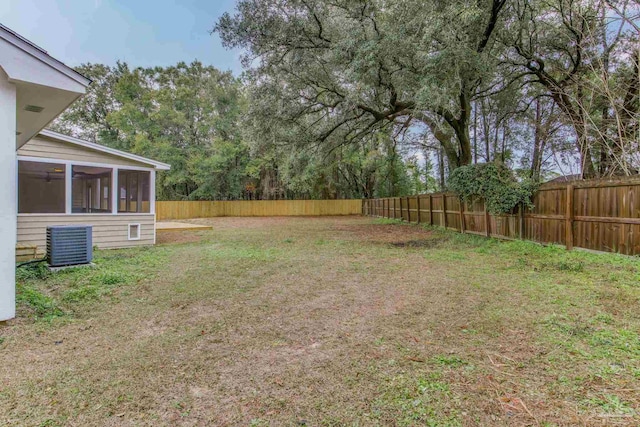 view of yard featuring central air condition unit and a sunroom