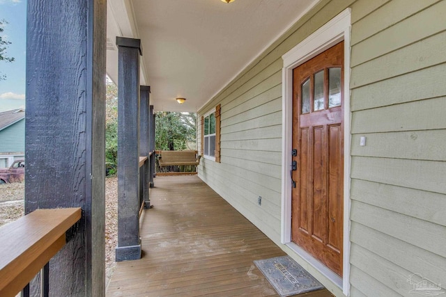 doorway to property featuring covered porch