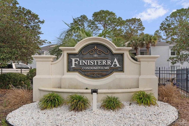 community / neighborhood sign featuring fence