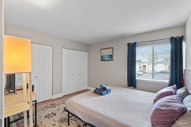 bedroom with wood finished floors and baseboards