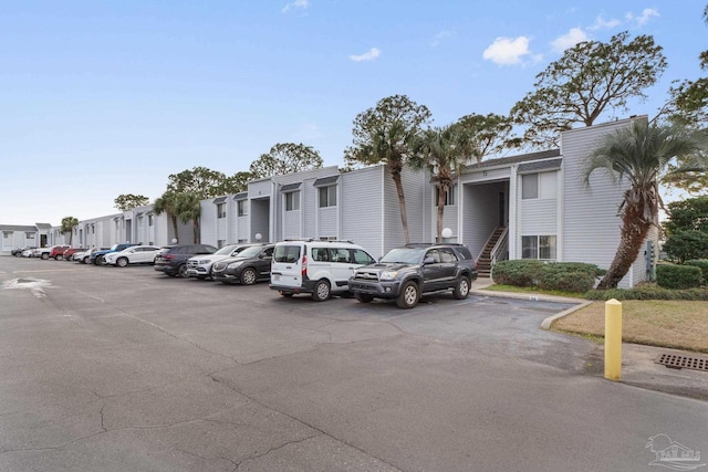 uncovered parking lot featuring a residential view