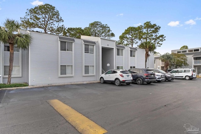 view of building exterior featuring uncovered parking