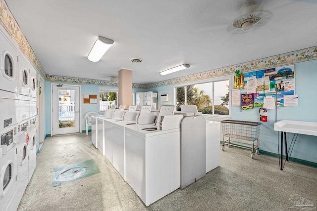 common laundry area featuring stacked washer and clothes dryer, visible vents, light carpet, separate washer and dryer, and wallpapered walls