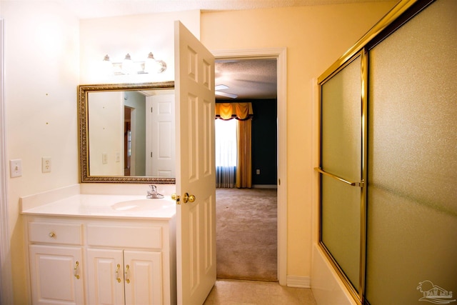 full bath with vanity and bath / shower combo with glass door