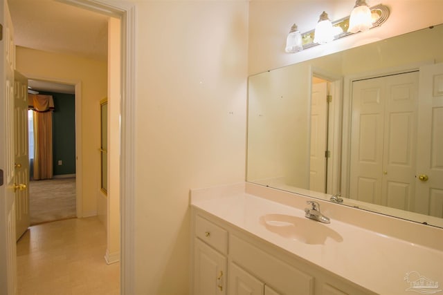 bathroom featuring vanity, baseboards, and a shower
