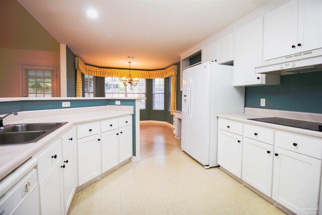 kitchen with under cabinet range hood, white appliances, a chandelier, a sink, and light floors