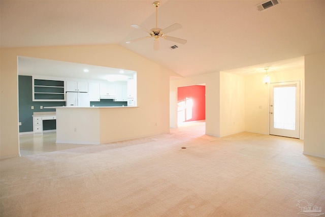 unfurnished living room with lofted ceiling, light carpet, ceiling fan, and baseboards