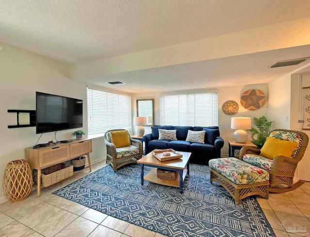 living room featuring a textured ceiling and tile patterned floors