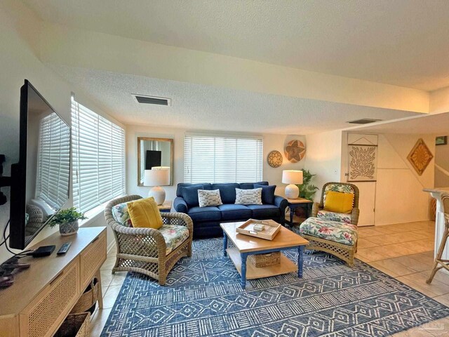 living room featuring tile patterned flooring and a textured ceiling