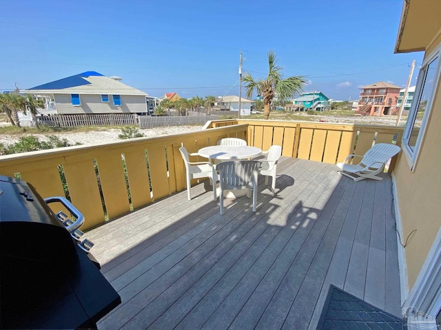 wooden deck featuring a grill