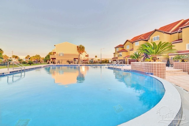 pool at dusk with a patio