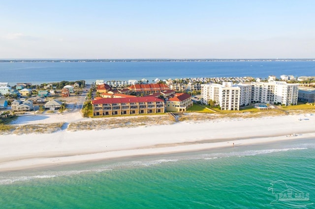 drone / aerial view featuring a water view and a view of the beach