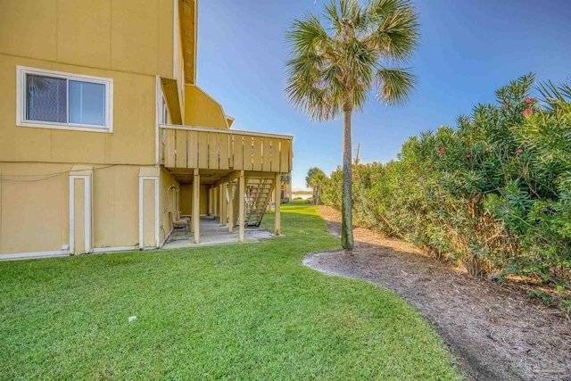 view of yard with a wooden deck and a patio area