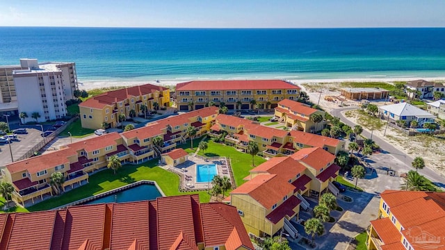 birds eye view of property with a view of the beach and a water view