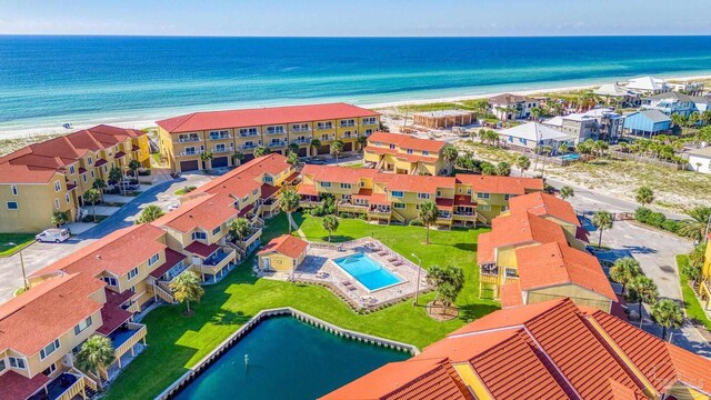 aerial view with a water view and a beach view