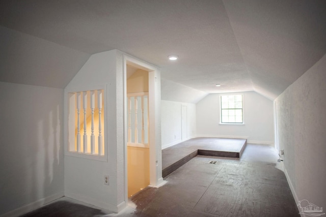 additional living space featuring lofted ceiling and baseboards