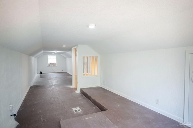 bonus room featuring visible vents, baseboards, vaulted ceiling, and cooling unit