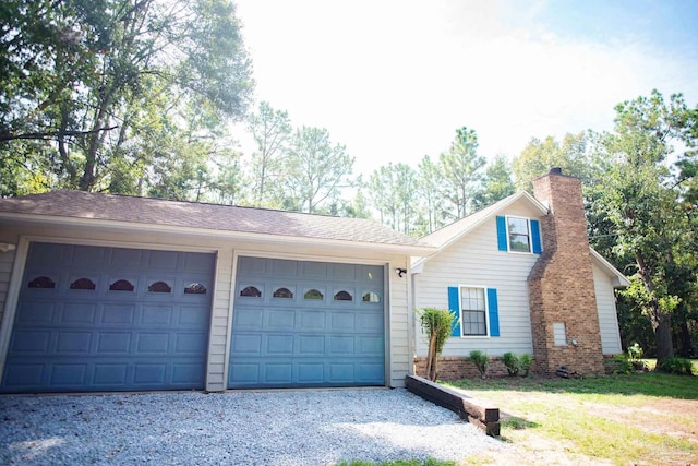 exterior space with gravel driveway and a chimney