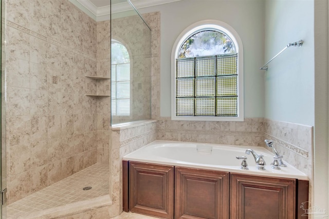 bathroom featuring a garden tub, ornamental molding, and a tile shower