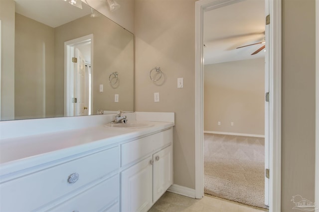 bathroom with ceiling fan, baseboards, and vanity