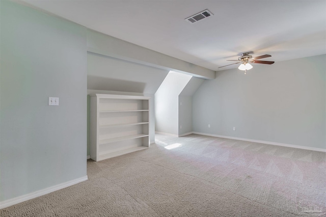 bonus room with carpet floors, built in features, lofted ceiling, visible vents, and baseboards