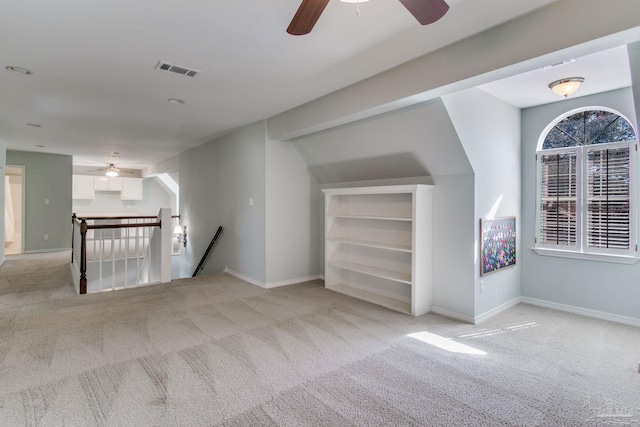 empty room featuring light carpet, visible vents, and baseboards