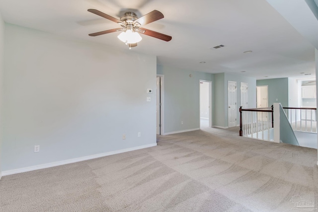 unfurnished room featuring visible vents, light carpet, and baseboards