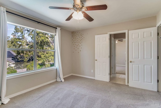 unfurnished bedroom with carpet flooring, ceiling fan, and baseboards