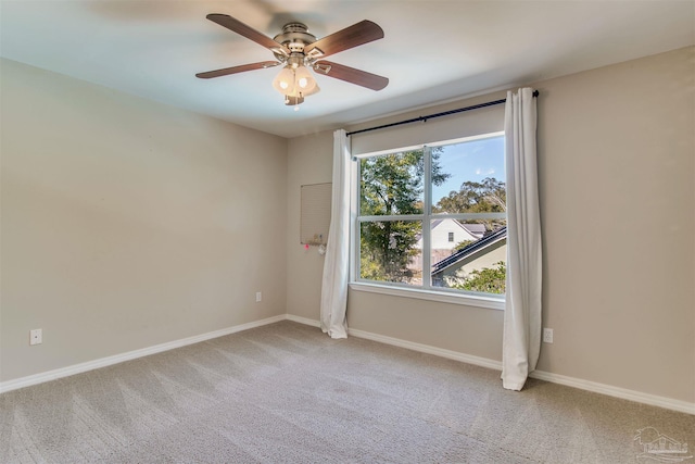 unfurnished room featuring carpet flooring, a ceiling fan, and baseboards