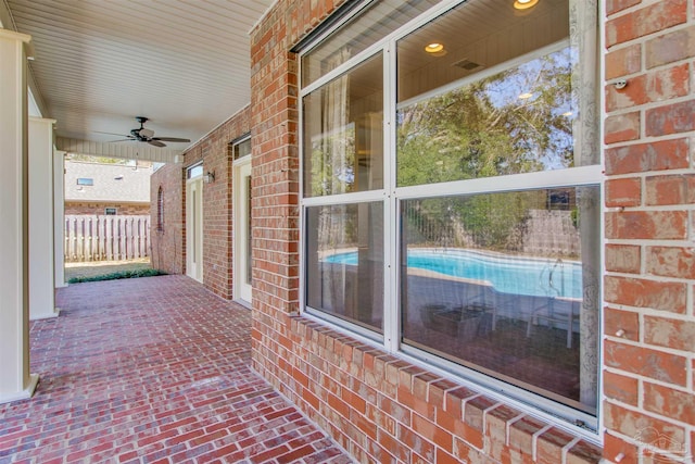 view of patio featuring ceiling fan and fence