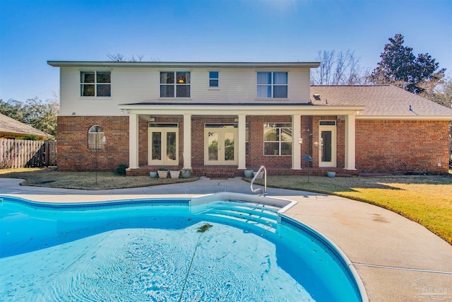 view of swimming pool featuring a fenced in pool, french doors, a yard, a patio, and fence