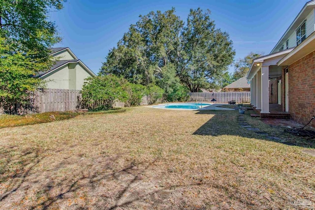 view of yard featuring a fenced in pool and a fenced backyard