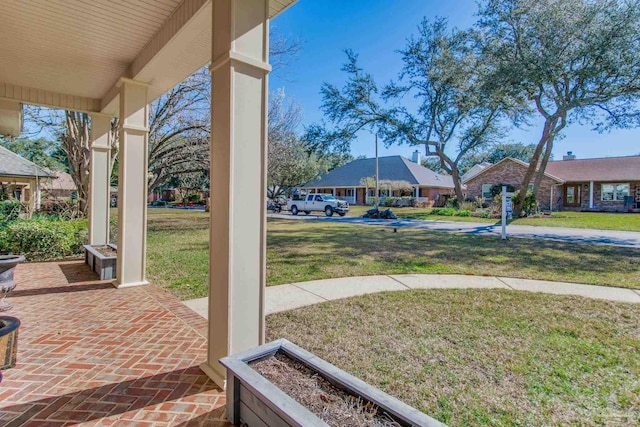 view of yard featuring covered porch