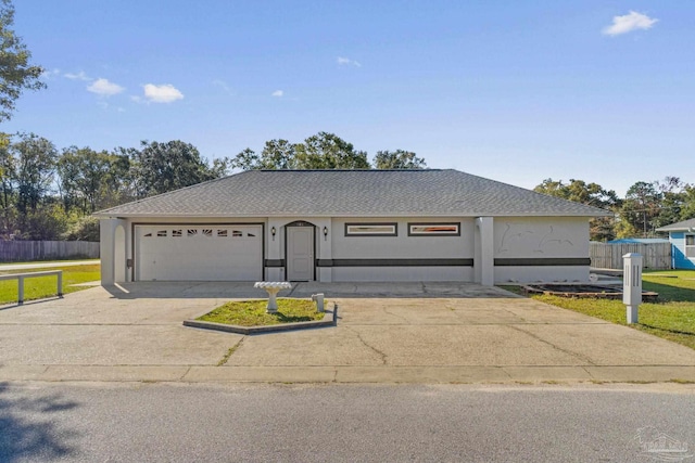 single story home featuring a garage and a front yard