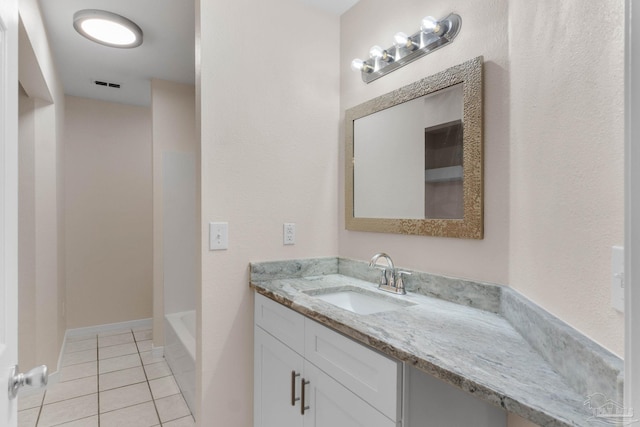 bathroom featuring tile patterned flooring and vanity