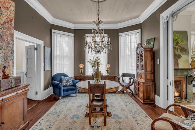 living area with a wealth of natural light, dark wood-type flooring, and ornamental molding