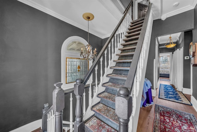 staircase with wood-type flooring, crown molding, and a notable chandelier