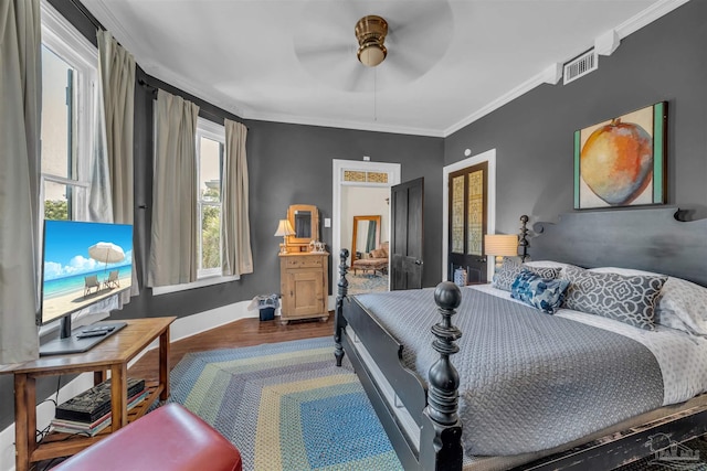 bedroom with hardwood / wood-style flooring, ceiling fan, and crown molding