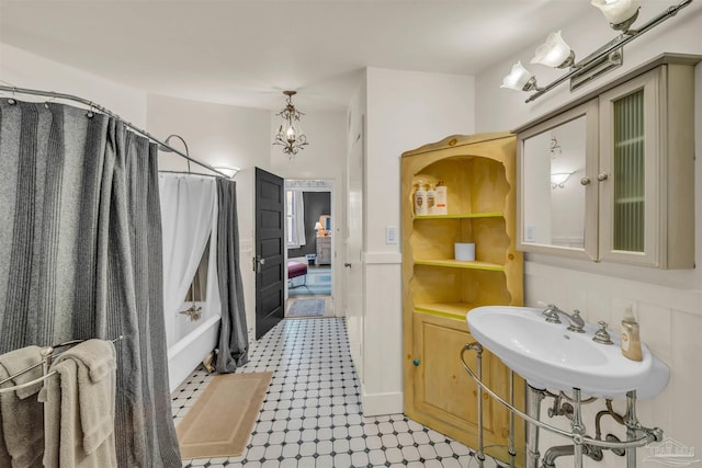 bathroom featuring shower / bath combo with shower curtain and sink