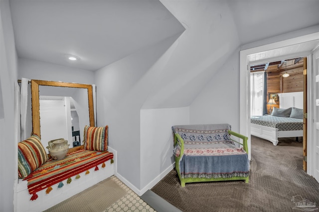 sitting room with carpet and vaulted ceiling