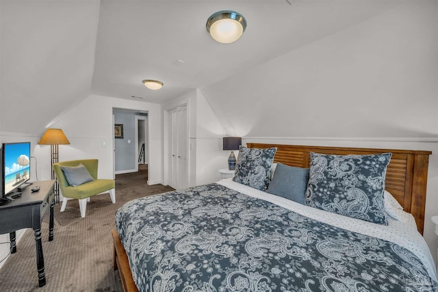 carpeted bedroom with lofted ceiling