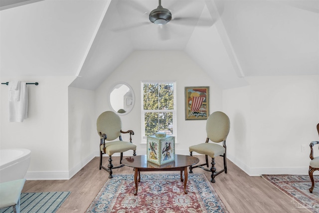 sitting room featuring ceiling fan, light hardwood / wood-style flooring, and lofted ceiling