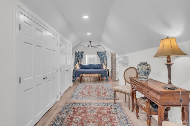 bedroom with light hardwood / wood-style floors and lofted ceiling