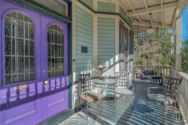 wooden terrace featuring covered porch