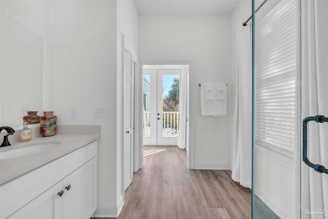 corridor featuring light hardwood / wood-style flooring and sink