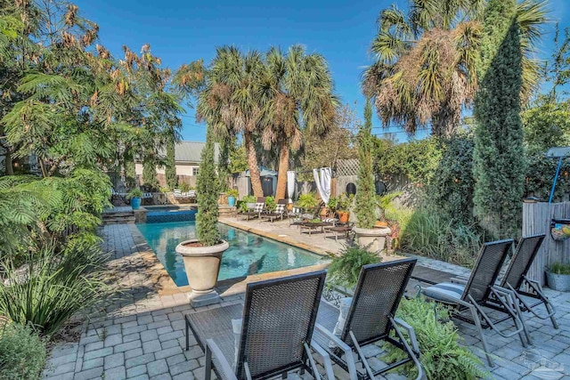 view of patio / terrace with a fenced in pool