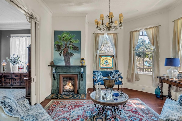 sitting room with dark hardwood / wood-style floors, crown molding, a chandelier, and a tiled fireplace